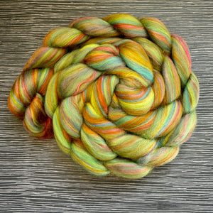 Multicolored skein of yarn on a wooden surface