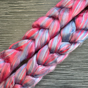 Braided fiber with red and gray colors on a textured surface