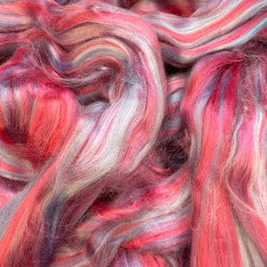 Close-up of multicolored fiber with pink, red, and gray hues.